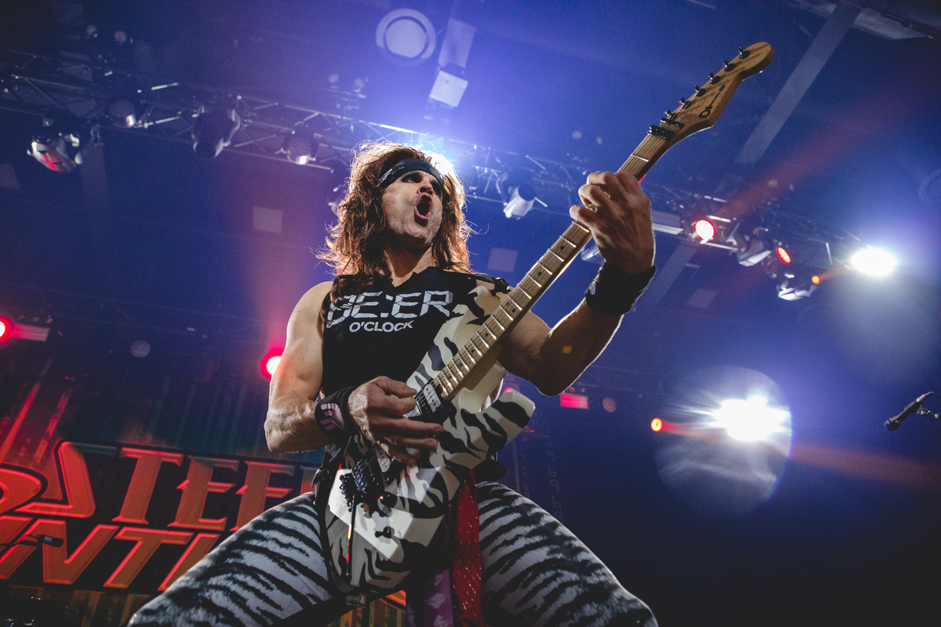 Photo of guitarist Satchel preforming onstage with Steel Panther