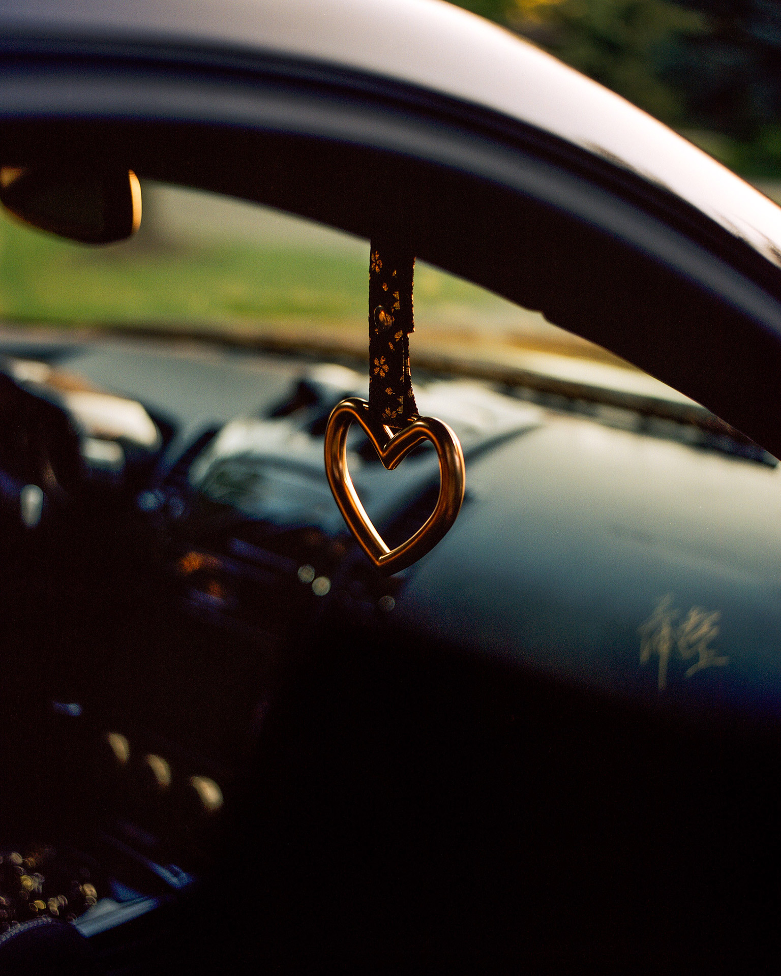 A Golden heart that is attached to the car.