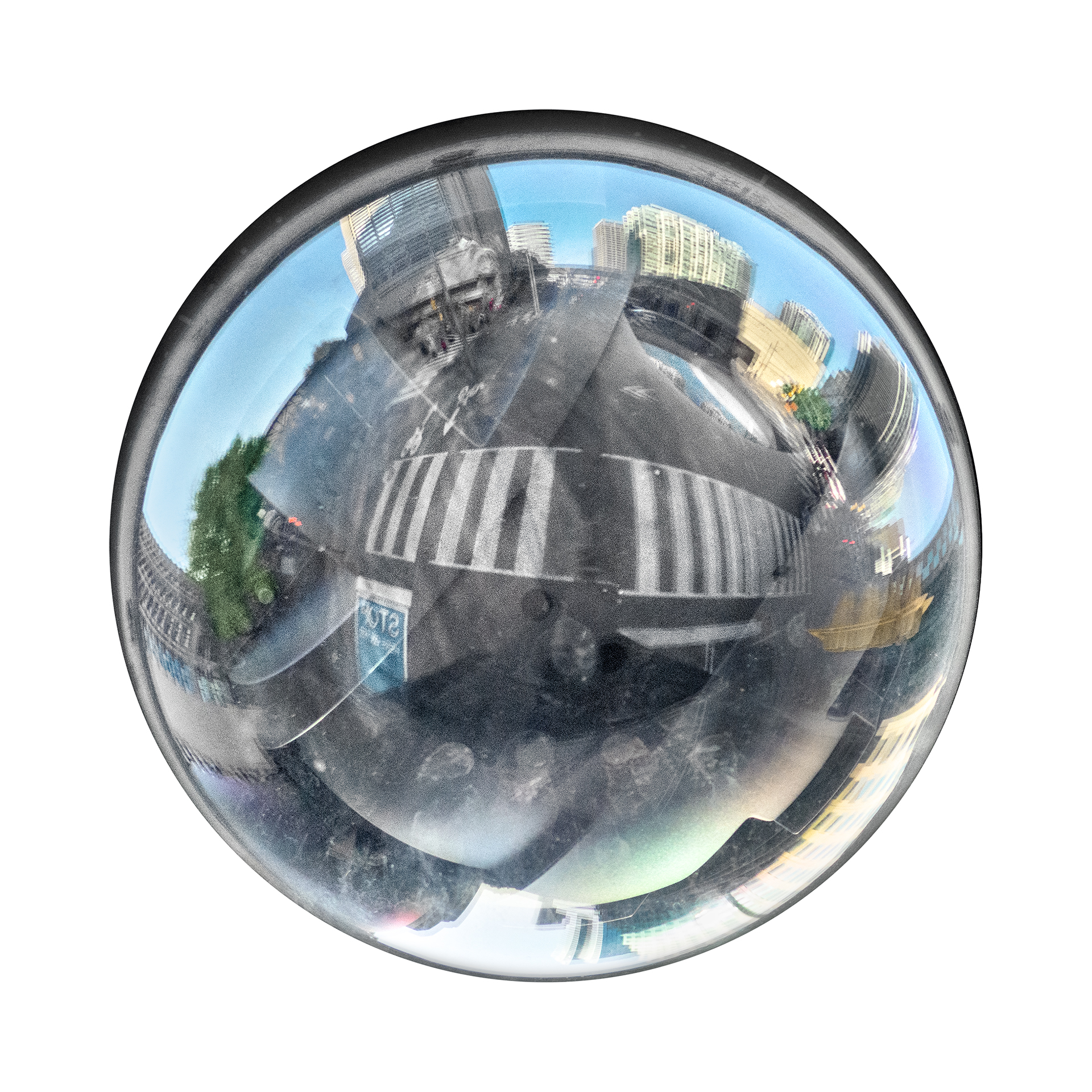 Distorted reflection of urban area and intersection in a circular security camera lens.