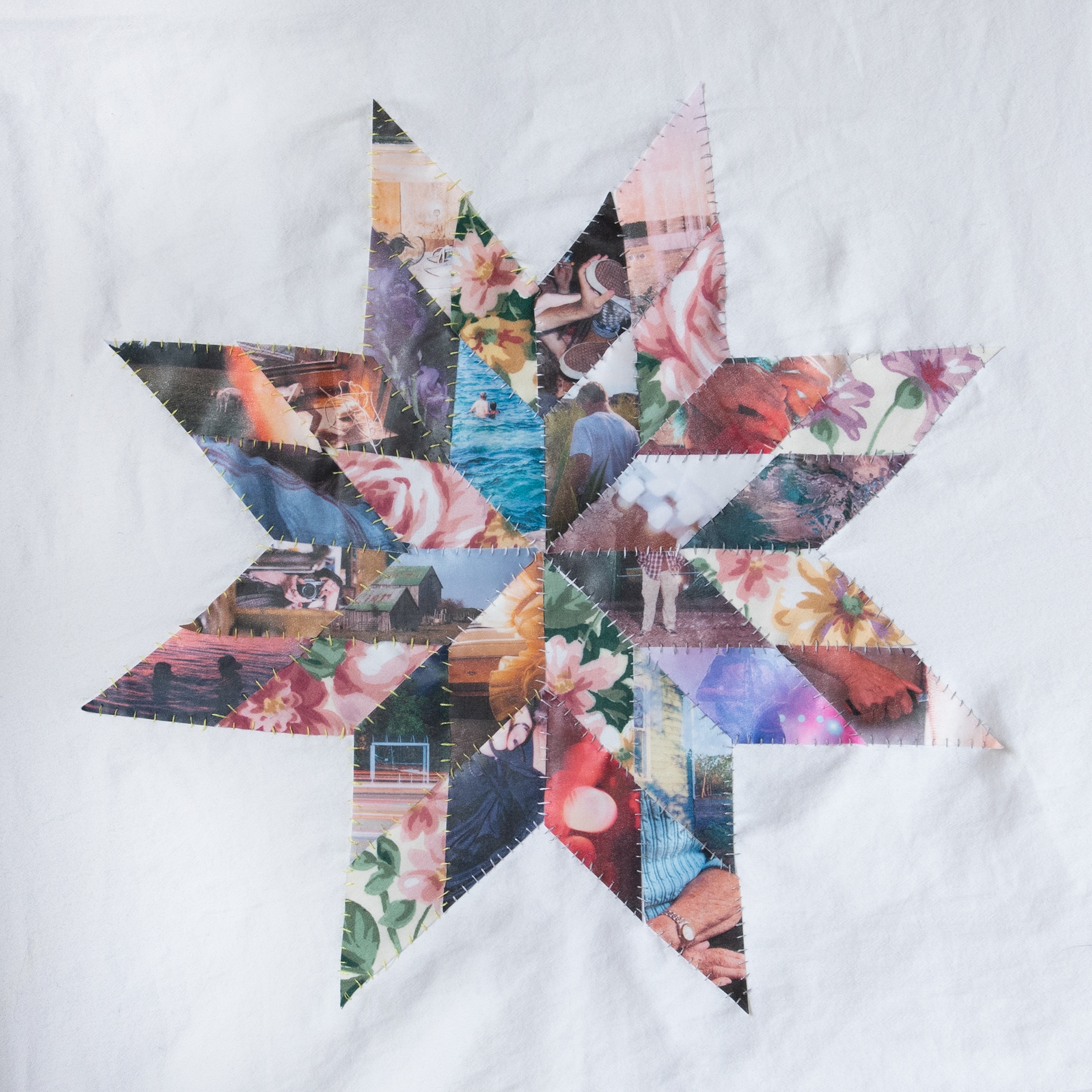Star Blanket: A hand-sewn eight point star design inspired by Indigenous star blankets/quilts. The diamond shapes are printed archival images from the artist and their idea of home; some images include friends, family, summer vacations, concerts, and places that feel comforting. There are also a few diamond shapes that have been cut from a floral fabric. The design is backed onto a white cotton bedsheet.