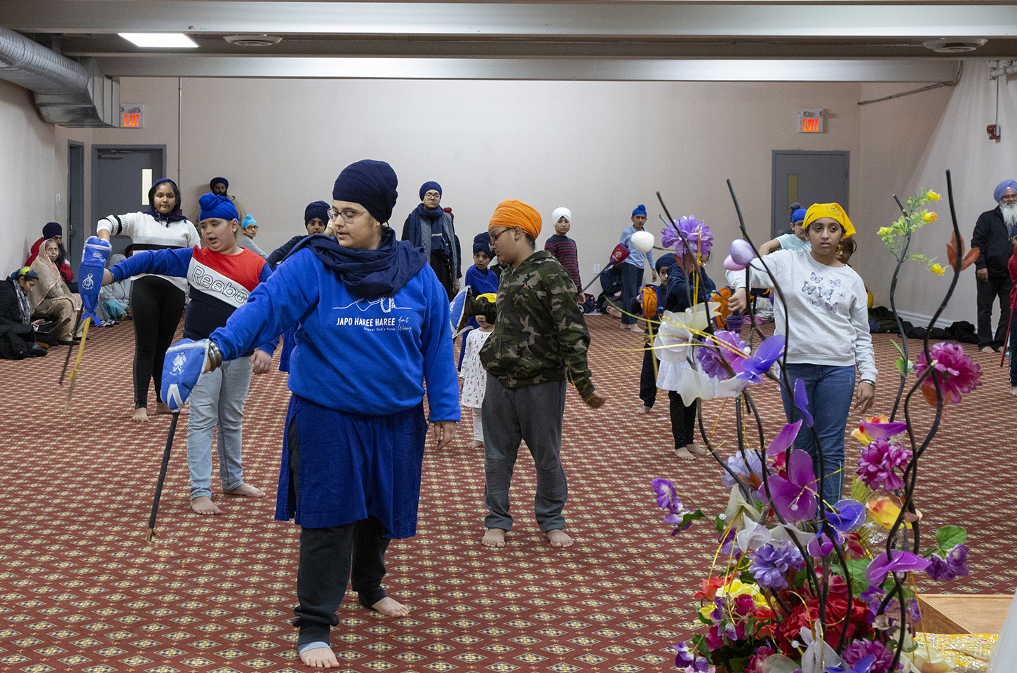 Woman teaching beginner students first Gatka fighting sequence
