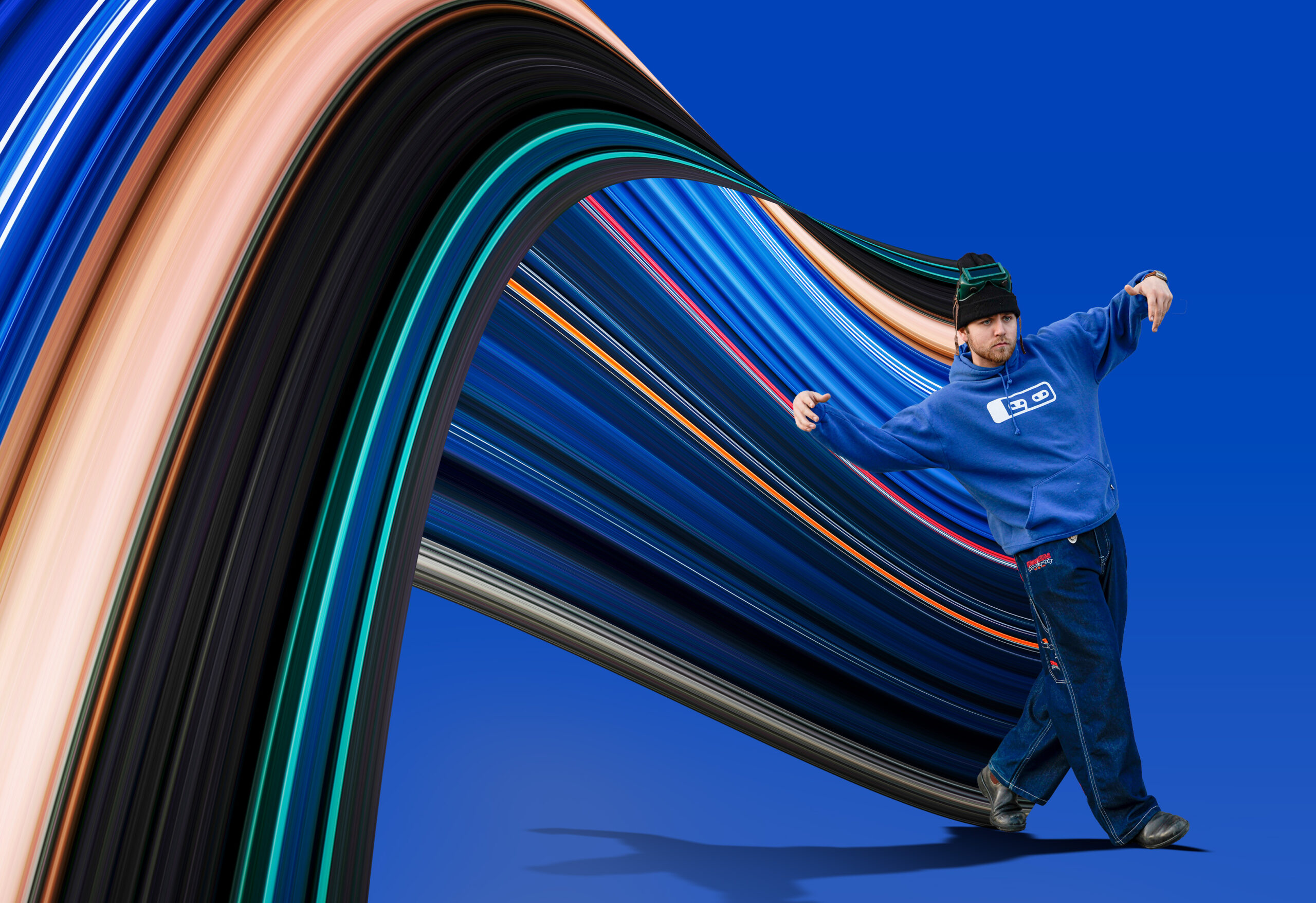 The model is in a blue hoodie and Elvis-style jeans, posing to his favourite song. While his arms are outstretched in his position, the colours from his clothing are also dragged away from him, exposing the movement and colours hidden within the image. The clothing was supplied by (KnockTwiceToronto clothing)