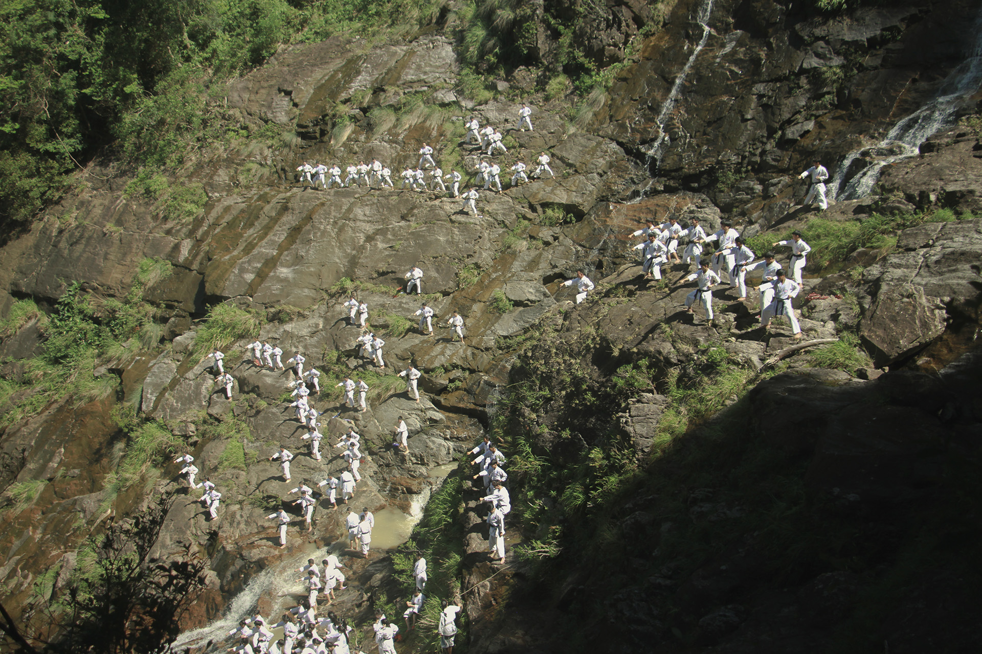 Black Belts on Bach Ma Mountain: 280 black belts Karate students train by a waterfall up the Bach Ma mountains in Central Vietnam.
