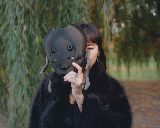 This is a picture of Kerry, freelance tattoo artist in Toronto with her 3D printed mast project, in Trinity Bellwoods Park.