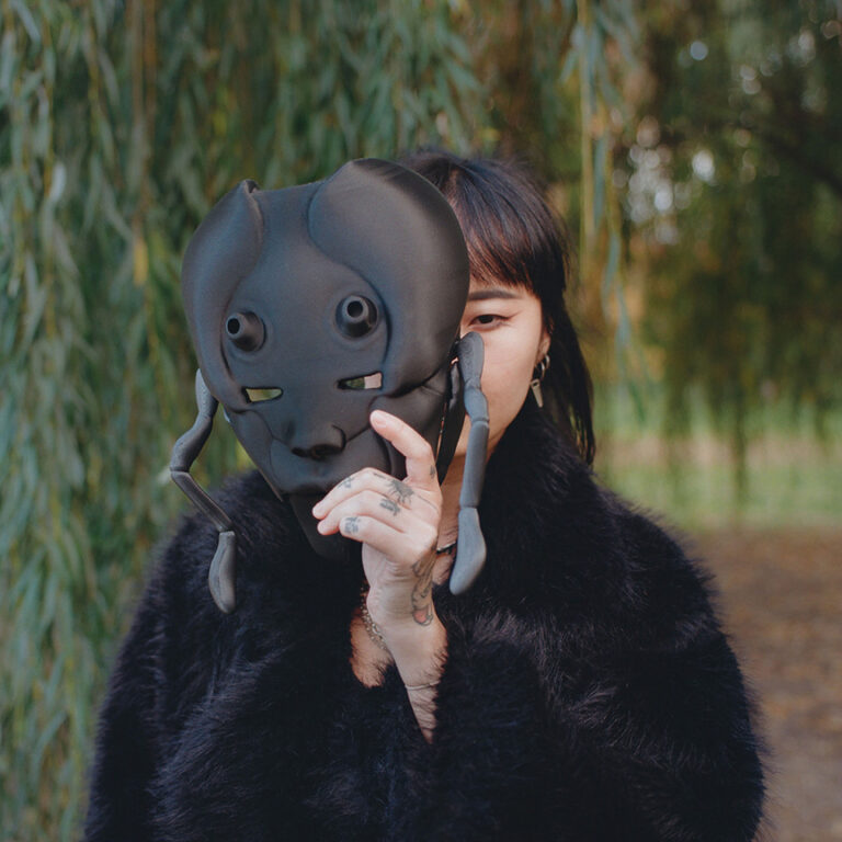 This is a picture of Kerry, freelance tattoo artist in Toronto with her 3D printed mast project, in Trinity Bellwoods Park.