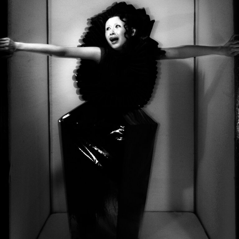 A full body image of a model yelling inside a confined space.