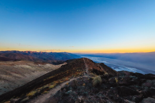 A lone hiker takes in panoramic Dante’s View at sunset in Death Valley National Park, California.